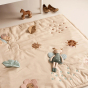 Roommate Baby Bugs Activity Blanket in a Pastel colour pictured on the floor in front of a crib