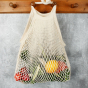 A Slice Of Green Organic Cotton Long Handled Shopping Bag hanging up containing fresh fruit and veg 