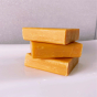 Stack of the Shower Blocks eco-friendly solid shampoo and conditioner bars on the side of a bath