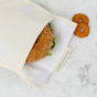 Close up of a bagel inside the A Slice of Green reusable velcro food storage baggie 