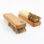 A Slice of Green wooden vegetable scrubbing brushes with plant-based bristles on a white background