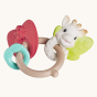 Sophie The Giraffe - Nature Chew Rattle. A natural rubber chew rattle, with a brown branch effect ring holding a light green apple ring, a red strawberry ring and a Sophie The Giraffe Ring