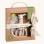 Sophie The Giraffe - So Pure Very Soft Teething Ring contents in their box, with a decorative ribbon on a cream background