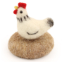 A made The Makerss - Amiguwoolli Tiny Chicken Mini Needle Felt Figure. The chicken is made from white felting wool, with black tail, wing and neck feather, a black stick in eye, yellow beak and a red comb and wattle.The chicken is sat on a felted brown ba