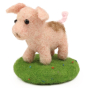 A fully made The Makerss - Amiguwoolli Tiny Pig Mini Needle Felt Figure. The pig is made from pink woolen felt, stick in eyes, with brown nostrils and an brown muddy patch on its back. The pig is stood on a green felted base with very small red and blue d