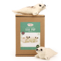 The Makerss Needle Felt Seal Pups. Two beautifully crafted seal pups laid on top and at the bottom of their box