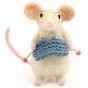 A closer look at the details on the The Makerss Needle Felt Knitting Mouse. A beautifully crafted white mouse wearing glasses with a pink tail and feet, knitting a blue outfit and stood on a white background
