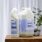  Bio-D 750ml natural toilet cleaner and 5 Litre tub on a wooden table and white background 