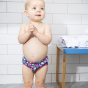 Toddler stood wearing the Totsbots mussel sea shell eco-friendly reusable baby swim pants 