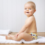Toddler sat on a white towel wearing the Totsbots surfs up eco-friendly reusable baby swim pants 