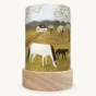 Toverlux Magic Light Wish - Spring Frolic. A translucent illustration of horses in a field and a small cottage, folded into a lantern to be used with a Toverlux Light Wish Base Light or LED light for illumination. On a cream background