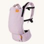 Tula free to grow baby carrier in the starling purple colour on a beige background