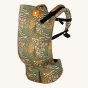 Tula preschool baby carrier in the meadow print on a beige background
