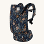 Tula Toddler Carrier in Lush Field design showing flowers on navy blue fabric