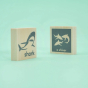 2 Uncle Goose plastic-free wooden collective noun toy blocks showing a shark and a shiver of sharks on a green background