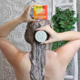 Picture of a woman washing her hair with the Lamazuna Vitality Boost solid shampoo.