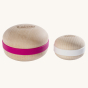 A Wobbel Big Macaron on the left with pink "filling" and a Wobbel Candy Macaron with white "filling" next to each other to show the size difference. Both Macarons show the natural Beech wood texture and wood grain, with a smooth finish
