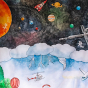 Wonderie Large Play Cloth - The Things Above. A closer look at the print designs on the cloth shows an outer space scene that includes, stars, planets, astronauts and space vehicles.