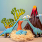 A Jurassic Play Scene of a Bumbu Volcano, Trees and Large Brontosaurus Dinosaurs watching over their nest of eggs