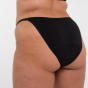 Woman stood backwards wearing the WUKA black flex detachable bikini period pants