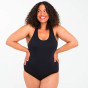 Woman stood on a grey background with her hands on her hips wearing the WUKA medium flow period swimsuit