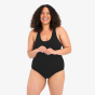 A woman models the WUKA Scoop Back Period Swimsuit - Light/Medium Flow. She is facing the camera and laughing.