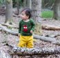 Toddler wearing LGR green applique fox tshirt with yellow pants in forest