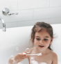 Child in a bath using the wand from the Jack N' Jill Blissful Bubbles Bubble Bath with Bubble Wand