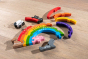 Alphabet Jigsaw sustainable coloured wooden Rainbow jigsaw game laid out on a wooden floor background