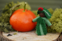 Ambrosius handmade Christmas yew fairy figure stood on some wood next to an orange and green moss