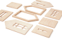 Pieces of the Babai toys sustainable natural wooden dollhouse spread out on a white background