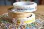 Stack of babipur birthday design tapes. English Happy Birthday, kraft Hppy Birthday and Welsh Penblwydd Hapus designs