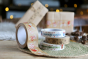 Babipur eco paper tape in the festive Christmas prints stacked on a green placemat in front of some Christmas presents