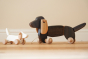 Bajo handmade wooden dachshund puppy and dachshund pull along toys on a wooden floor