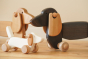 Close up of the Bajo wooden dachshund puppy and pull along dachshund on a wooden floor