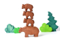 Bumbu sustainably sourced wooden bear toys stacked in a tower in front of some green wooden tree toys on a white background