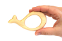 Hand holding the Bumbu sustainable wooden whale baby teething toy on a white background