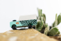 Close up of the Candylab kids wooden jeep toy on a rock next to a mini cactus