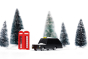 Candylab wooden London taxi car toy on a white snow scene background next to some miniature trees and red phonebox