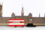 Candylab red double decker bus and black taxi car toys in front of a miniature Buckingham Palace