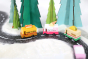 3 Candylab handmade wooden toy trucks driving on a toy road in a snowy Winter scene