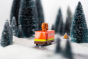 Close up of the Candylab collectable wooden pretzel van toy on a toy road surrounded by miniature trees and snow