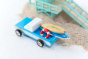 Close up of the Candylab longhorn blue toy with miniature wooden surfboards in the back