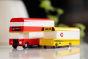 Candylab red London bus and yellow school bus toys on a white background