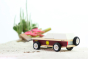 Close up of the Candylab kids wooden lone sheriff jeep on some sand in front of a cactus