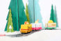 Close up of the Candylab hot dog, ice cream and taco trucks driving on a toy road in a snowy Winter scene