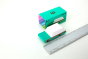 Candylab kids teal wagon car toy on a white background next to its cardboard box and metal ruler