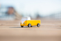 Close up of a Candylab eco-friendly wooden campervan toy on a beige background