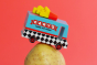 Candylab French Fry Candyvan car toy on top of a potato on a red background