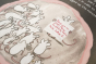 Close up of some illustrated mice, from The Cats Who Wanted More childrens book, holding up a sign that reads, "there is no more food. Those ruthless rats have taken it."